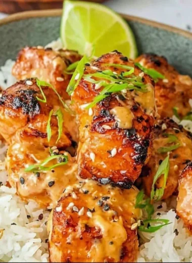 Spicy Bang Bang Salmon served on a plate with garnishes.
