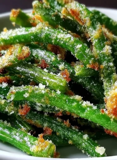 Crispy garlic parmesan green beans served in a bowl, garnished with parmesan cheese