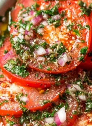 Delicious marinated tomatoes served in a bowl with herbs and spices