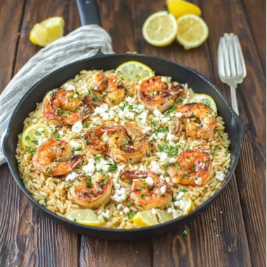 A delicious plate of one pot orzo with shrimp and feta cheese served with herbs
