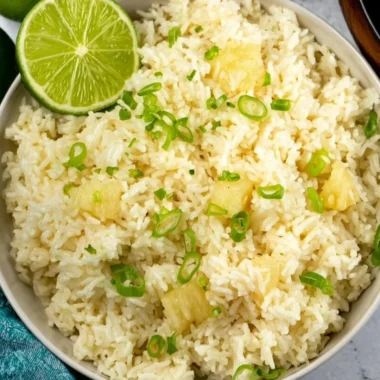 Delicious Pineapple Rice served in a bowl with colorful vegetables and herbs.