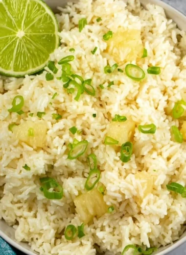 Delicious Pineapple Rice served in a bowl with colorful vegetables and herbs.