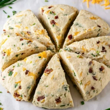 Freshly baked Bacon Cheddar Chive Scones on a wooden table