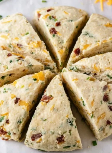Freshly baked Bacon Cheddar Chive Scones on a wooden table