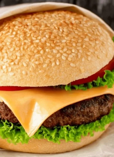 Juicy hamburger patty on a grill ready for serving