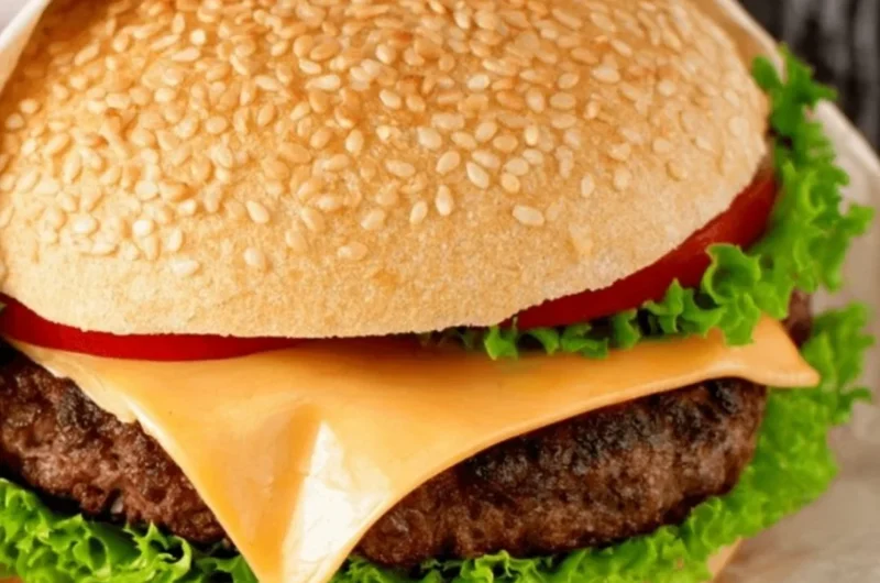 Juicy hamburger patty on a grill ready for serving