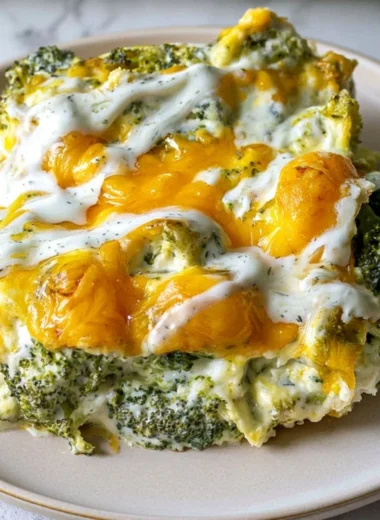 Cheesy Broccoli Casserole freshly baked in a dish with melted cheese on top