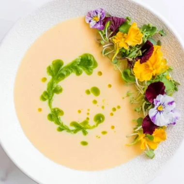 Chilled peach soup garnished with mint leaves in a bowl