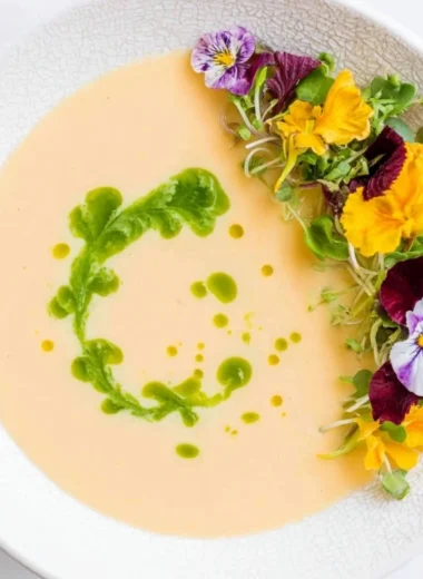 Chilled peach soup garnished with mint leaves in a bowl