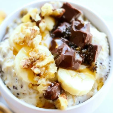 Bowl of Chunky Monkey Overnight Oats topped with banana and chocolate chips