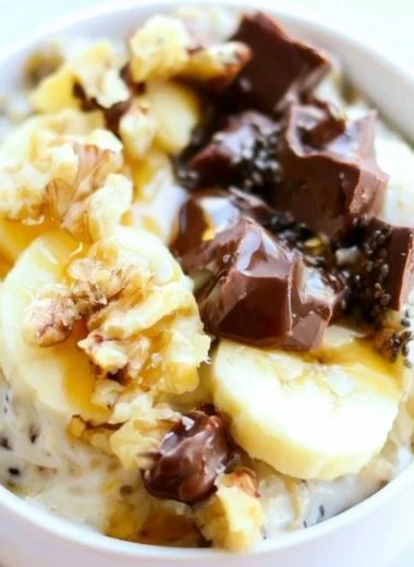 Bowl of Chunky Monkey Overnight Oats topped with banana and chocolate chips