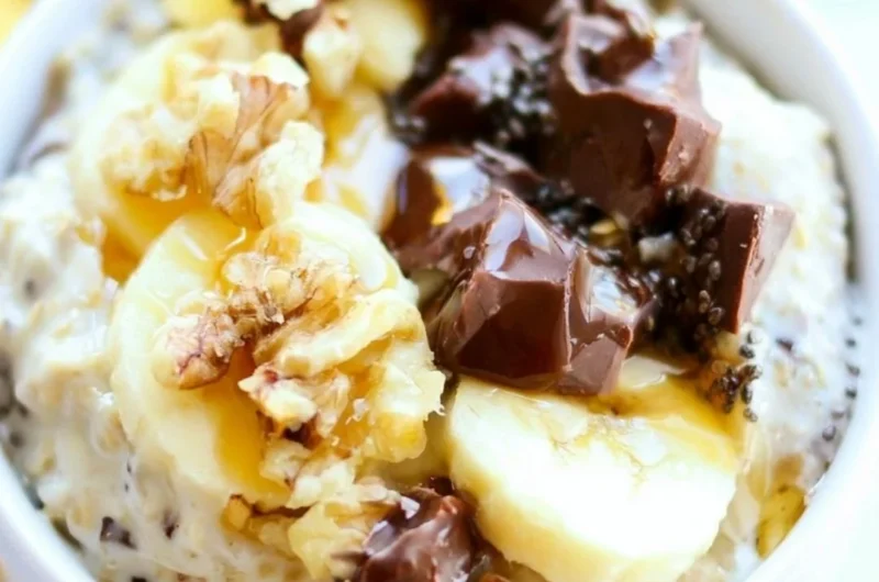 Bowl of Chunky Monkey Overnight Oats topped with banana and chocolate chips