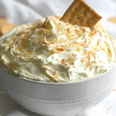 Coconut Cream Pie Dip served in a bowl with coconut garnish