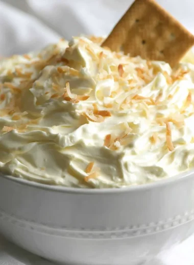 Coconut Cream Pie Dip served in a bowl with coconut garnish