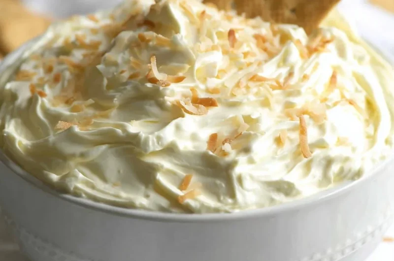Coconut Cream Pie Dip served in a bowl with coconut garnish