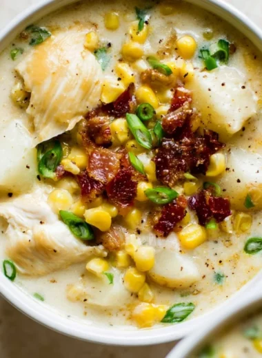 Bowl of easy chicken and corn chowder garnished with herbs