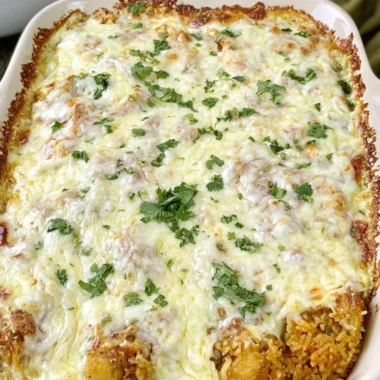 Delicious dump and bake queso chicken and rice dish ready to serve.