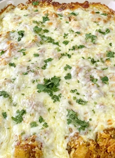 Delicious dump and bake queso chicken and rice dish ready to serve.