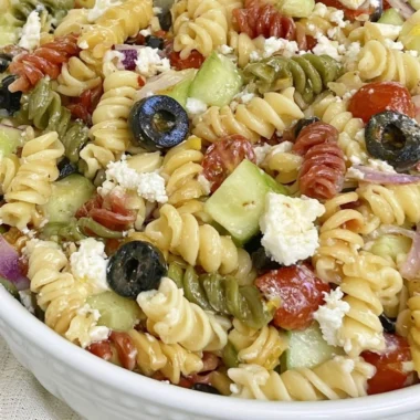 Bowl of easy Italian pasta salad with fresh vegetables and dressing