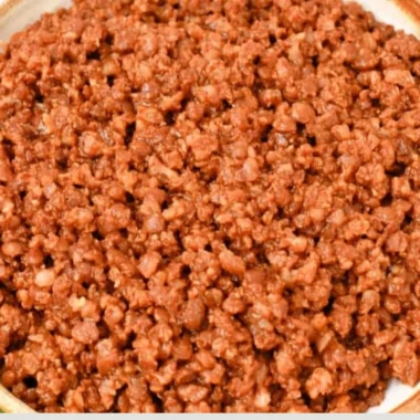 Bowl of easy lentil taco meat served in taco shells with toppings