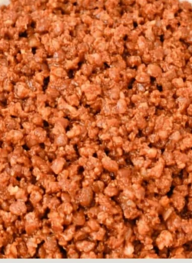 Bowl of easy lentil taco meat served in taco shells with toppings