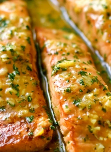 Delicious garlic butter salmon fillet with herbs and lemon on a plate