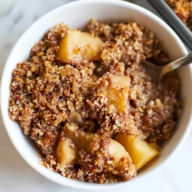 Healthy breakfast apple crumble topped with oats and nuts