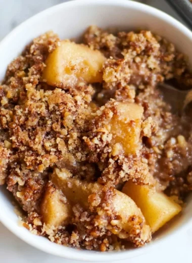 Healthy breakfast apple crumble topped with oats and nuts