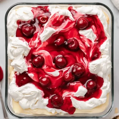 Heaven on Earth Cake served with whipped cream and fresh berries