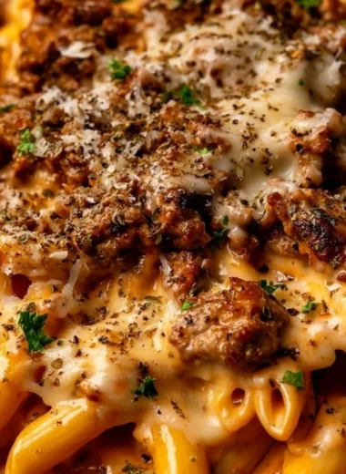 Creamy beef pasta dish with high protein content, garnished with herbs.