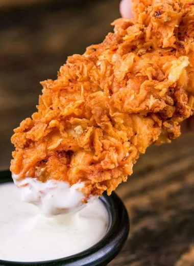 Plate of crispy homemade buttermilk chicken tenders served with dipping sauce.