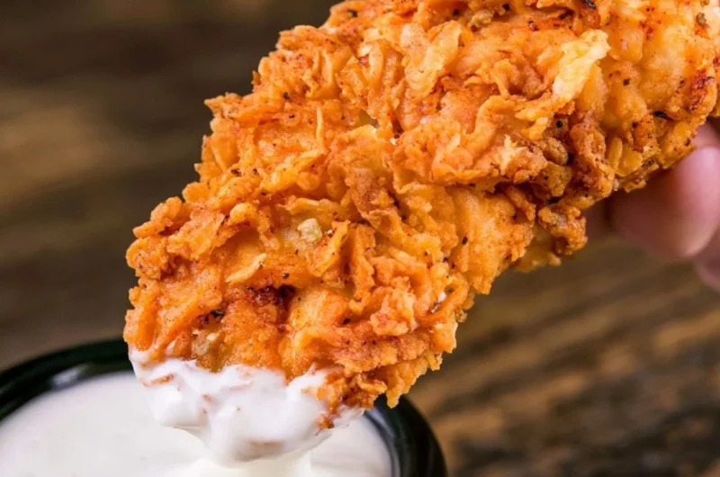 Plate of crispy homemade buttermilk chicken tenders served with dipping sauce.