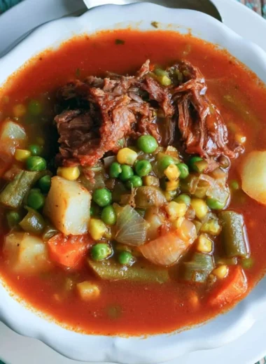 Bowl of my mom's old-fashioned vegetable beef soup with colorful veggies and beef chunks