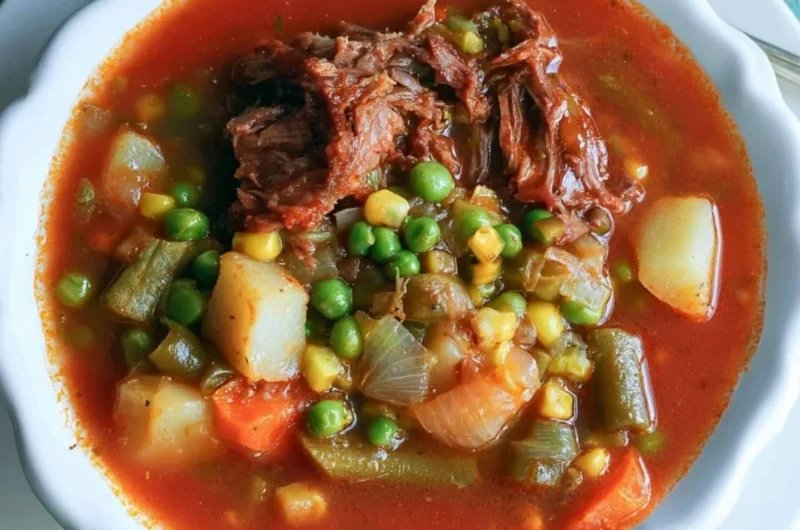 Bowl of my mom's old-fashioned vegetable beef soup with colorful veggies and beef chunks