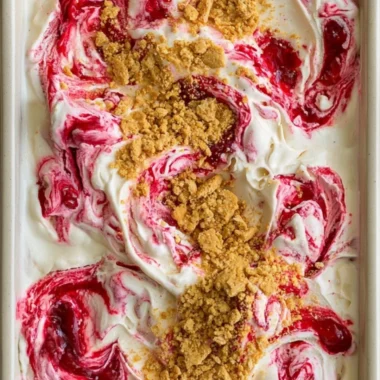 Delicious no churn cherry cheesecake ice cream in a bowl with cherries on top