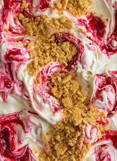 Delicious no churn cherry cheesecake ice cream in a bowl with cherries on top