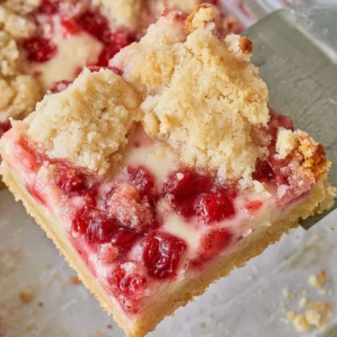 Delicious strawberry pie bars on a wooden table with fresh strawberries