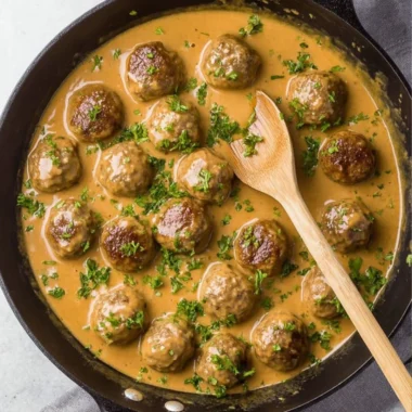 Serving of Swedish Meatballs with creamy sauce and herbs on a plate