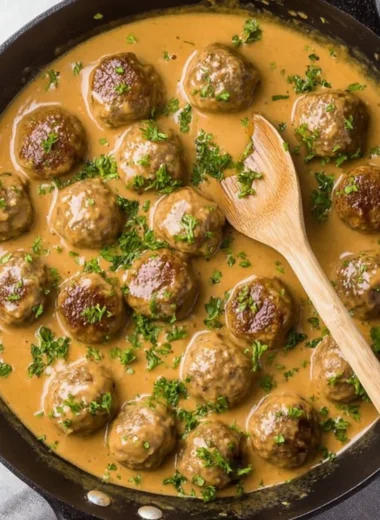 Serving of Swedish Meatballs with creamy sauce and herbs on a plate