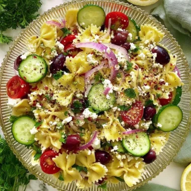 Delicious tangy Mediterranean pasta salad with fresh veggies and herbs.