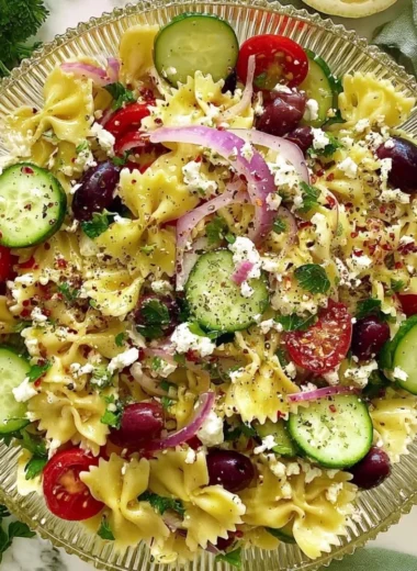 Delicious tangy Mediterranean pasta salad with fresh veggies and herbs.