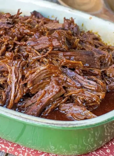 Texas Cola Shredded Beef Brisket served on a plate with garnishes