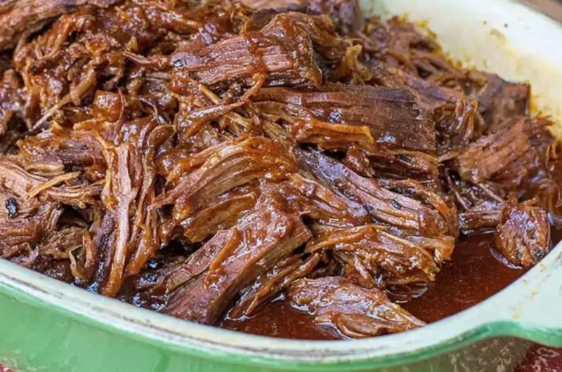 Texas Cola Shredded Beef Brisket served on a plate with garnishes
