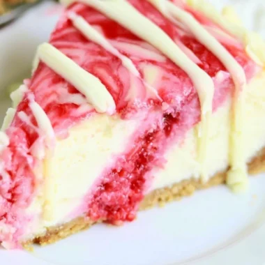 Delicious white chocolate raspberry swirl cheesecake slice