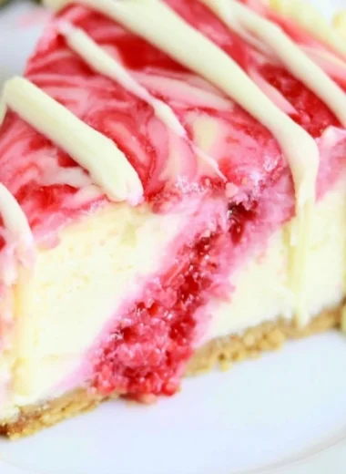 Delicious white chocolate raspberry swirl cheesecake slice