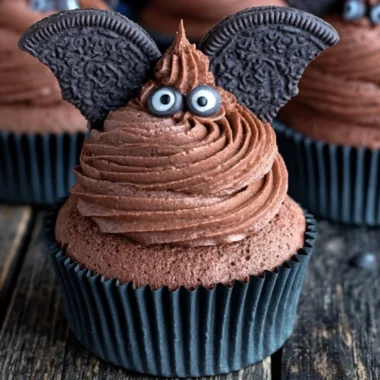 Halloween-themed bat cupcake decorated with chocolate frosting and bat wings.
