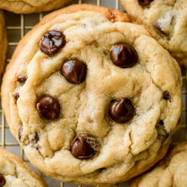 Freshly baked chocolate chip cookies on a cooling rack