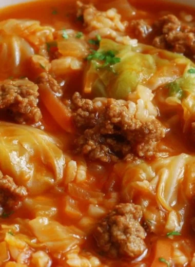 Bowl of savory cabbage roll soup garnished with fresh herbs and spices.