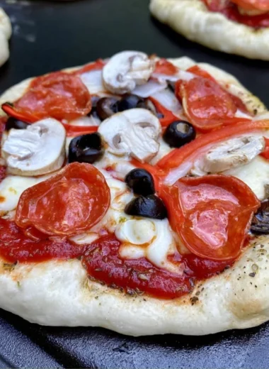 Homemade delicious pizza cooking on a Blackstone griddle.