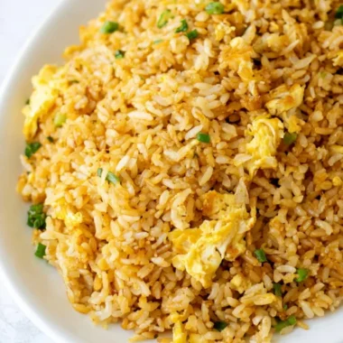 Delicious easy fried rice dish garnished with vegetables and egg